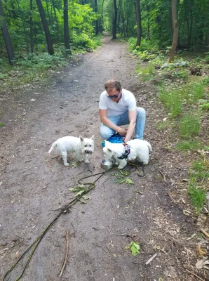 Are Two Westies Better Than One? : Giving water to two westies during a forest walk: one male and one female